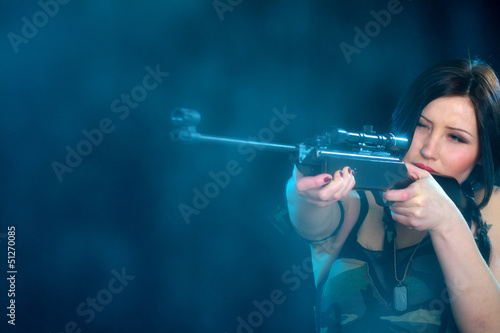 Photo: Beautiful woman holding weapon Beautiful woman holding weapon