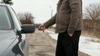 Man with remote trying to unlock the car door