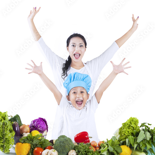 Photo: Happy family arms raised - isolated Happy family arms raised - isolated