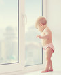 baby girl looking out the window longing, sadness, and waiting