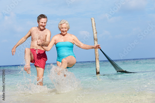 Photo: Senior Couple Splashing In Beautiful Tropical Sea Senior Couple Splashing In Beautiful Tropical Sea
