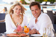 Photo: Couple Enjoying Meal In Outdoor Restaurant Couple Enjoying Meal In Outdoor Restaurant