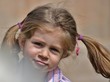 An extremely cute little girl with pigtails.