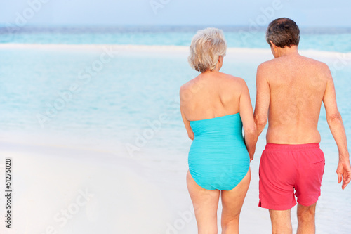 Photo: Rear View Of Senior Romantic Couple Walking In Tropical Sea Rear View Of Senior Romantic Couple Walking In Tropical Sea