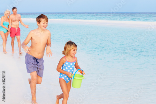 Photo: Grandparents And Grandchildren Having Fun On Beach Holiday Grandparents And Grandchildren Having Fun On Beach Holiday