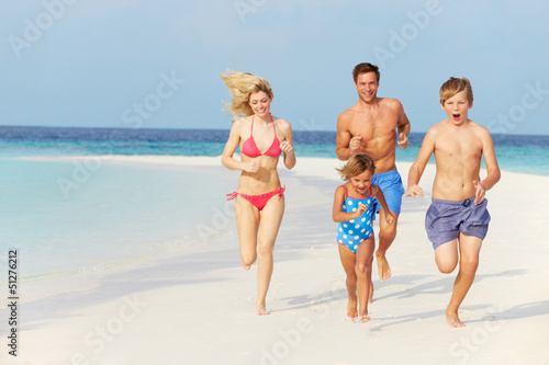 Photo: Family Having Fun On Beach Holiday Family Having Fun On Beach Holiday