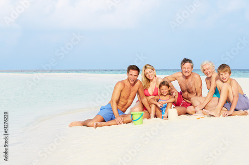 Photo: Multi Generation Family Having Fun On Beach Holiday Multi Generation Family Having Fun On Beach Holiday
