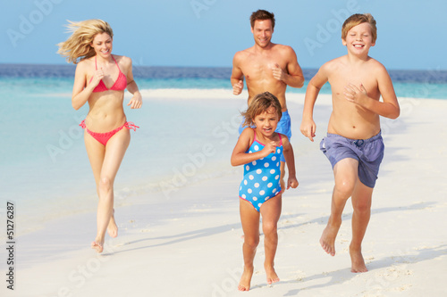 Photo: Family Having Fun On Beach Holiday Family Having Fun On Beach Holiday
