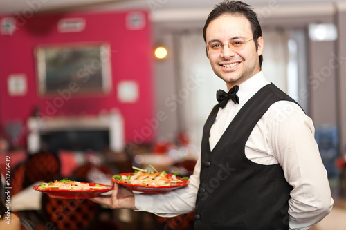 Photo: Waiter serving appetizers Waiter serving appetizers