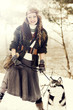 Photo: Happy young woman standing with siberian husky dog Happy young woman standing with siberian husky dog
