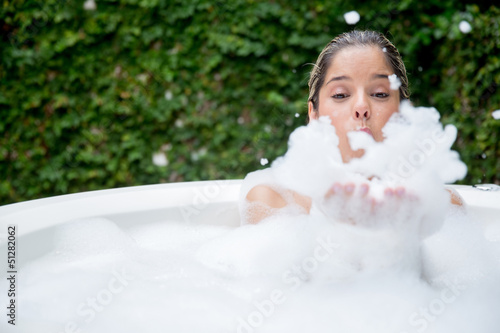 Photo: Happy woman taking a bubble bath Happy woman taking a bubble bath