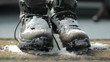 A pair of snowy boots dropped on a welcome mat