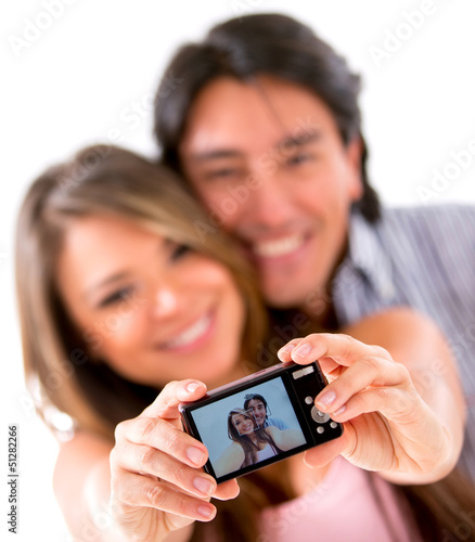 Photo: Happy couple taking a picture Happy couple taking a picture