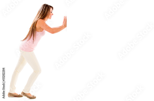 Photo: Woman pushing something Woman pushing something