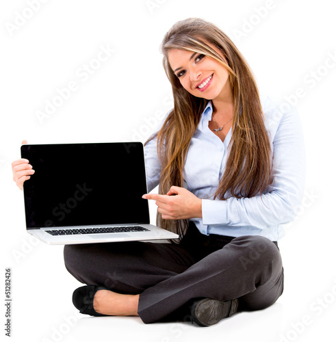 Photo: Business woman pointing on a laptop Business woman pointing on a laptop