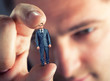 Small businessman in hand