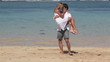 Video: Happy woman jumping on boyfriend and spinning together at beach Happy woman jumping on boyfriend and spinning together at beach
