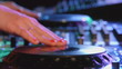 Female dj mixes the track at a party