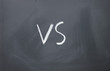vs sign written with chalk on blackboard
