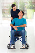 caring wife talking to disabled husband