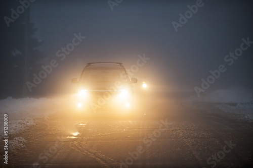 Photo: Headlights of car driving in fog Headlights of car driving in fog