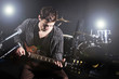 Man playing guitar during concert