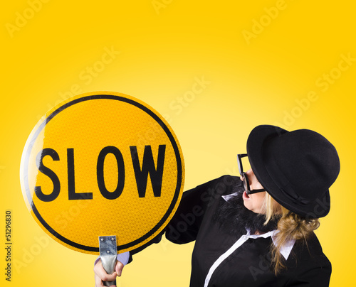 Photo: Man holding slow sign during adverse conditions Man holding slow sign during adverse conditions