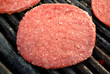 Raw Burger on a Grill with Garlic Powder