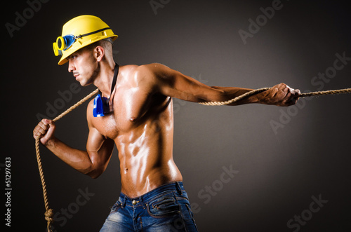 Photo: Nude builder pulling rope in darkness Nude builder pulling rope in darkness