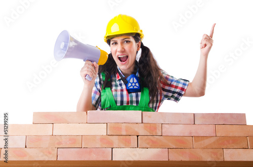 Photo: Woman with louspeaker near brick wall Woman with louspeaker near brick wall