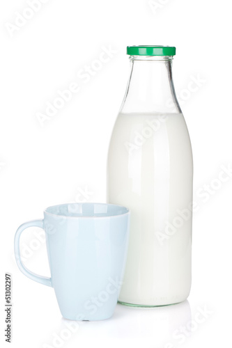 Photo: Cup of milk and glass bottle Cup of milk and glass bottle
