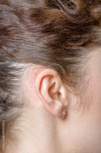 Photo: Young caucasian woman ear closeup. Young caucasian woman ear closeup.