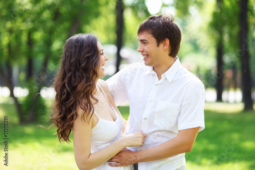 Photo: Young love Couple smiling under blue sky Young love Couple smiling under blue sky