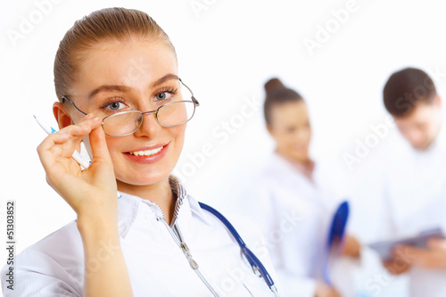 Photo: Young female doctor in white uniform Young female doctor in white uniform
