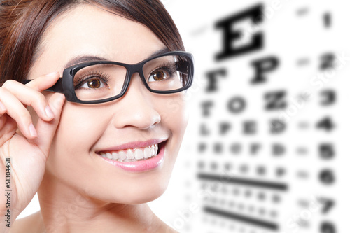 Photo: woman with glasses and eye test chart woman with glasses and eye test chart