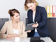 Two business women  working with tablet pc in the office