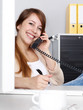 Female office assistant has a call at the office