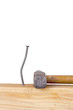 Crooked nail in the wooden board with a hammer