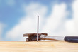 Hammer and nail with wooden board