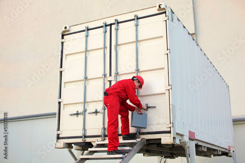 Photo: technician with tool case opening movable workshop in container technician with tool case opening movable workshop in container