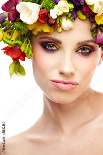 Photo: Woman with hairstyle and freesia flower. Isolated. Woman with hairstyle and freesia flower. Isolated.