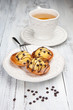 Sweet cakes with a cup of tea on a white table