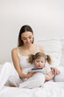 Cute little girl using tablet with her mother