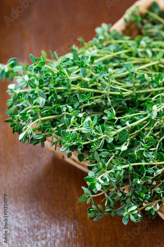 Photo: Fresh thyme in a basket on wooden background Fresh thyme in a basket on wooden background