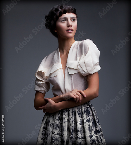Photo: Nostalgia. Styled Woman in Retro Apparel with Braided Hair Style Nostalgia. Styled Woman in Retro Apparel with Braided Hair Style