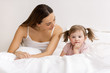 Pretty little girl sulking  with her mother