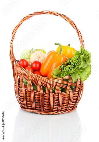 Photo: Fresh vegetables in wicker basket isolated on white Fresh vegetables in wicker basket isolated on white