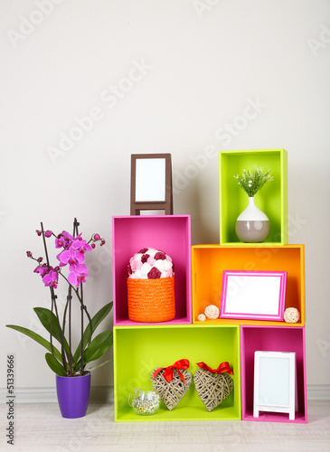Photo: Beautiful colorful shelves with different home related objects Beautiful colorful shelves with different home related objects