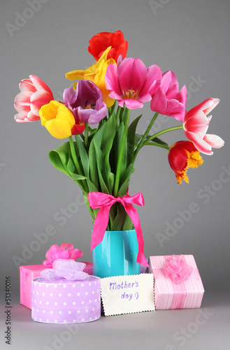 Photo: Beautiful tulips in bouquet with gifts and note Beautiful tulips in bouquet with gifts and note