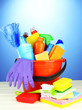 Cleaning items in bucket on  color background